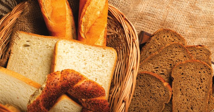 Assorted breads and buns in a wicker basket