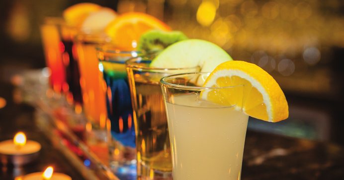 Glasses of juice and soft drinks with citrus slices